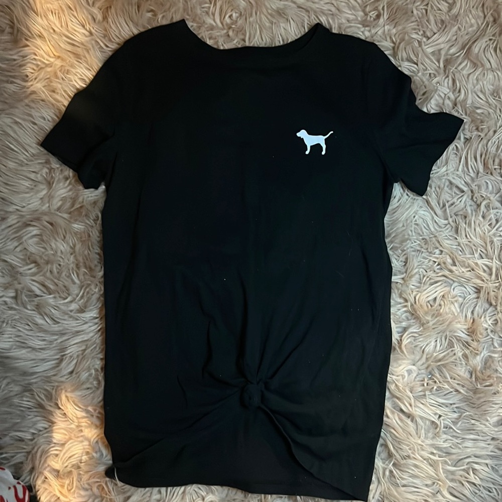 A black and white shirt the has a knock tie in the center very cute